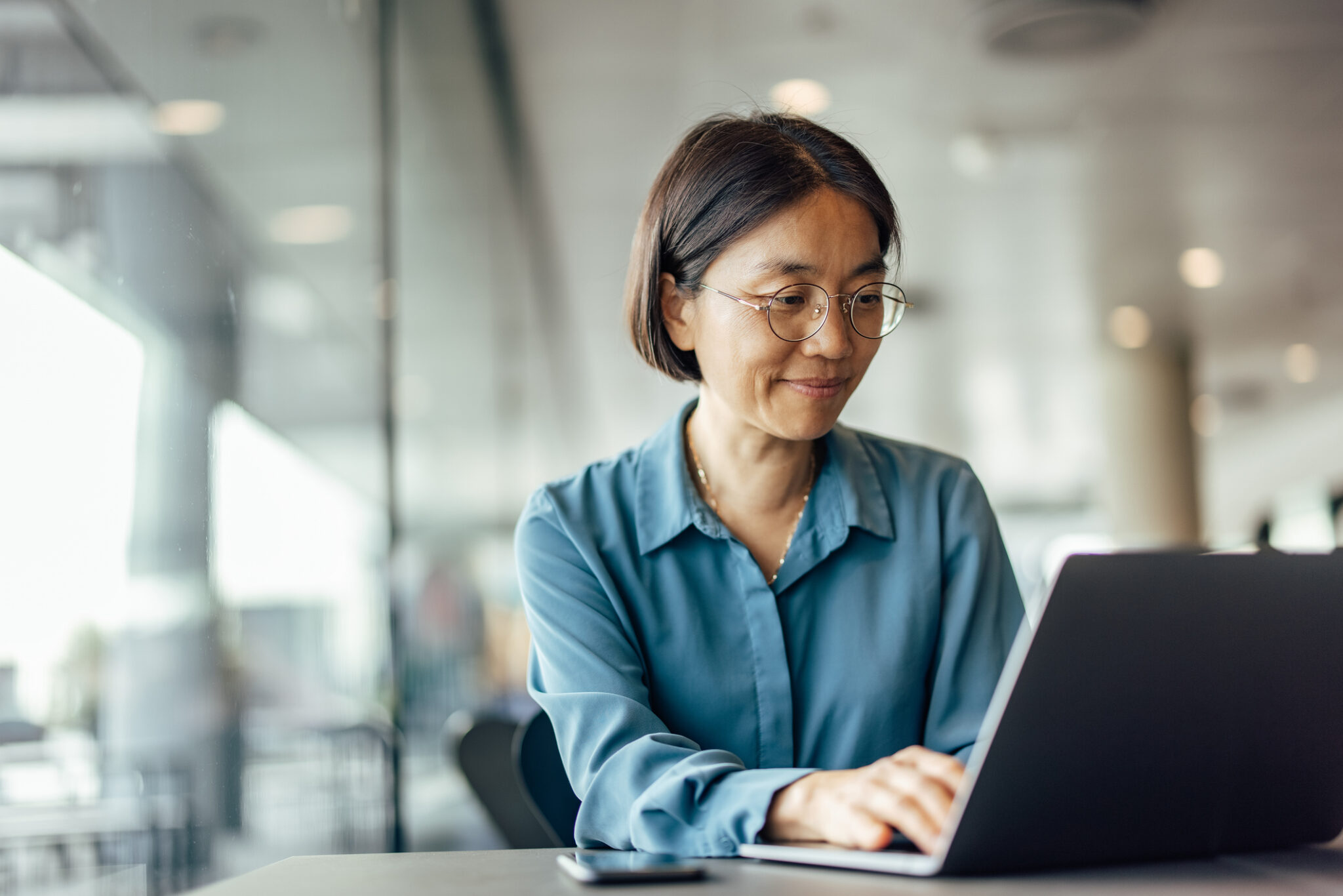 Female professional reviewing equity options on a digital platform as part of a tender offer decision.
